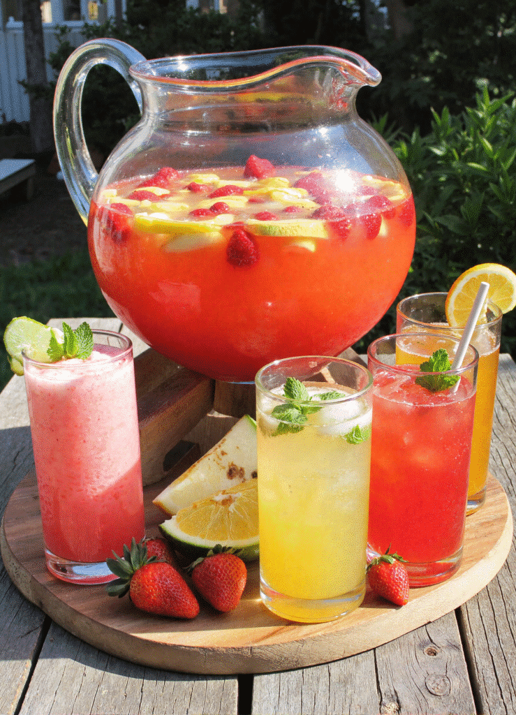 5 Refreshing Summer Punch Recipes served in a glass punch bowl with fruit and mint