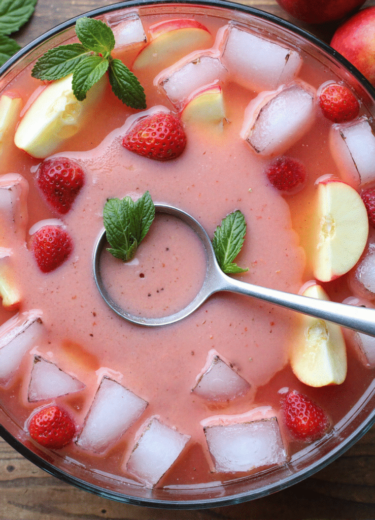 Creamy strawberry apple punch recipe with mint and fruit garnish
