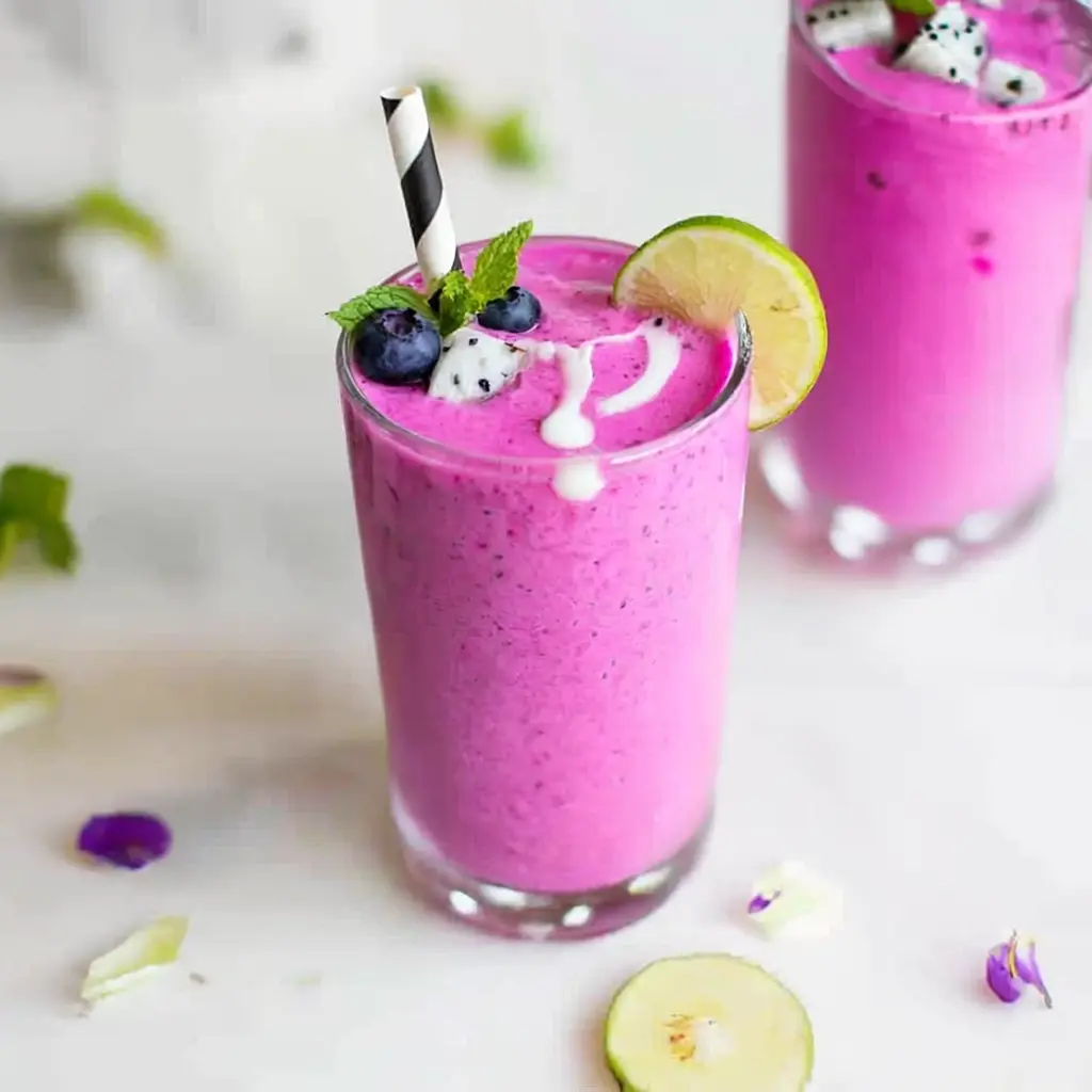 Vibrant dragon fruit smoothie in a tall glass