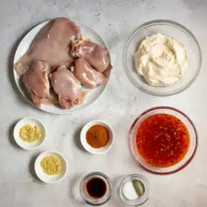 Ingredients for Bang Bang Chicken including skinless chicken breasts, sweet chili sauce, spices, and creamy sauce mix.