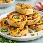cheesy taco pinwheels recipe close-up stacked on plate