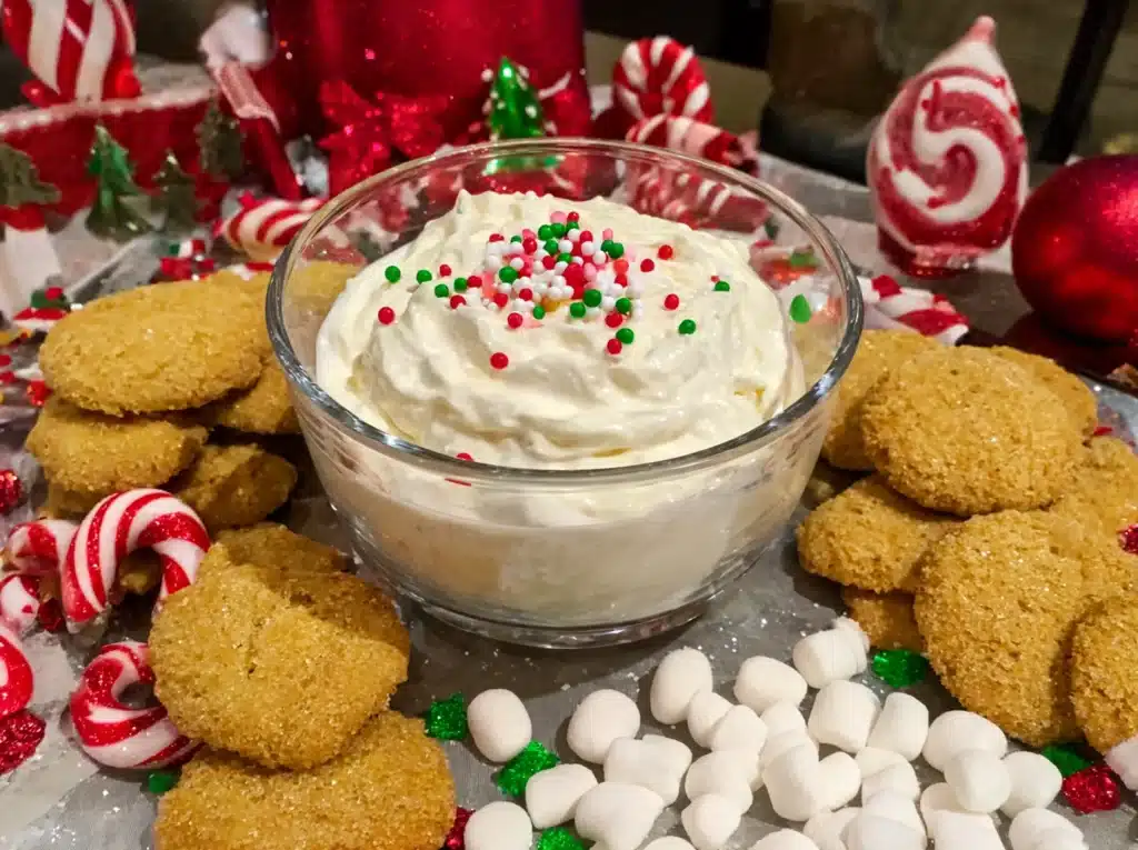 Holiday-themed Funfetti Dip with red and green sprinkles served on a decorated Christmas table
