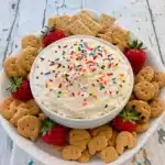 Homemade Funfetti Dip in a white bowl topped with rainbow sprinkles