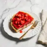 slice of strawberry pizza recipe served on white porcelain plate