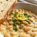 Creamy Lemon Garlic Butter Beans in a glossy lemon-garlic sauce