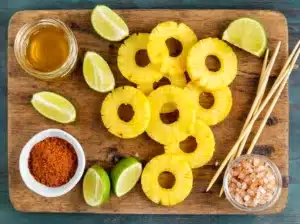 Pineapple rings and seasonings ready for grilling