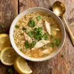 lemon chicken orzo soup in a bowl on table