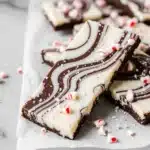 close-up of peppermint oreo white chocolate bark with dark swirl and peppermint bits