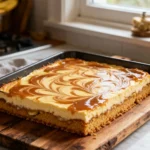 A full pan of Banana Blondie Cheesecake with caramel swirls.