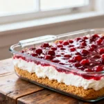 Cherry cheesecake lush recipe in a 9x13 glass dish with layers.