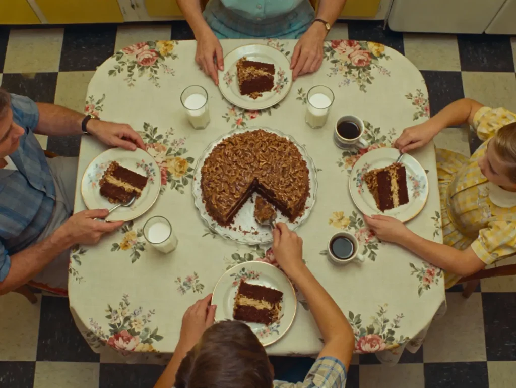 Family serving German chocolate cake 1957 at vintage table