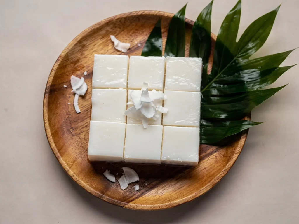 Haupia recipe served on a tropical wood platter with coconut garnish