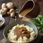 mushroom gravy recipe poured over mashed potatoes