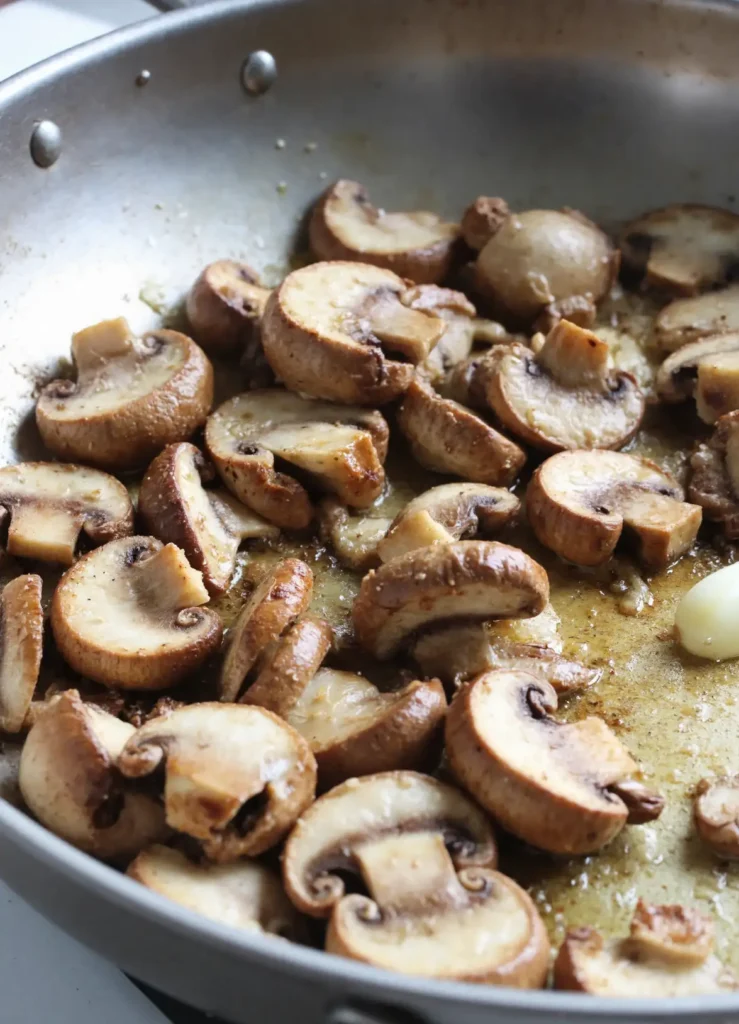 mushrooms sautéing in pan for mushroom gravy