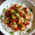Crockpot Kung Pao Chicken in a bowl with rice