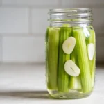 Low Carb Pickled Celery Snack in a mason jar with vinegar and garlic