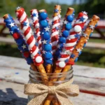 Patriotic Pretzel Rods in a mason jar for a 4th of July dessert table